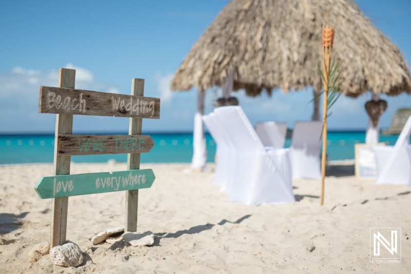 Beach wedding at Daaibooi in Curacao with decorations and ocean backdrop under bright skies