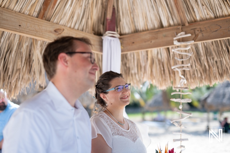 Couple exchanging vows during a beautiful wedding ceremony in Daaibooi, Curacao surrounded by tropical scenery