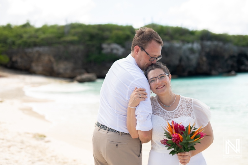 Couple celebrates their wedding on the serene Daaibooi beach in Curacao, surrounded by natural beauty and joy