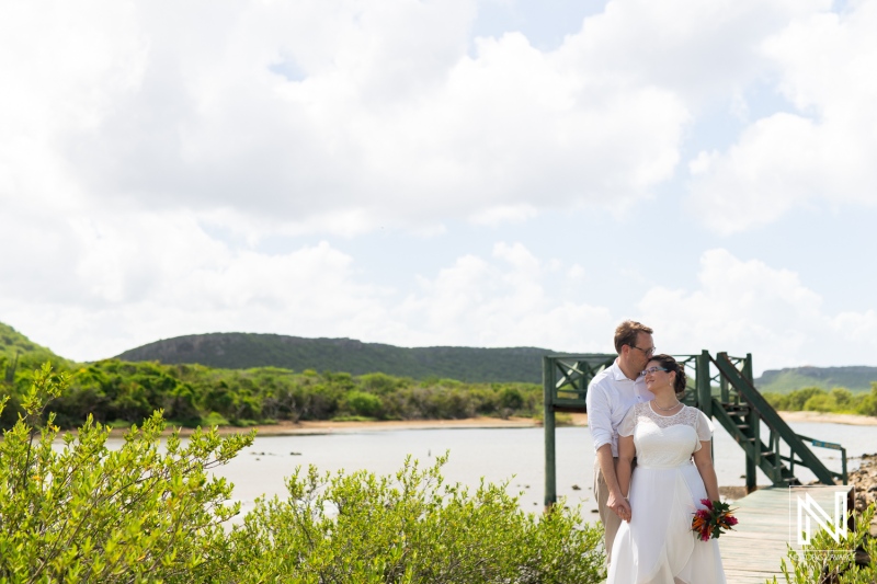 Couple celebrating a joyful wedding ceremony at Daaibooi in Curacao with scenic landscapes in the background