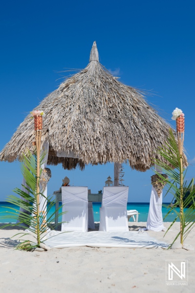 Relaxing Beachfront Cabana With White Chairs and Tropical Decor on a Sunny Day by the Ocean, Inviting Guests for a Serene Getaway