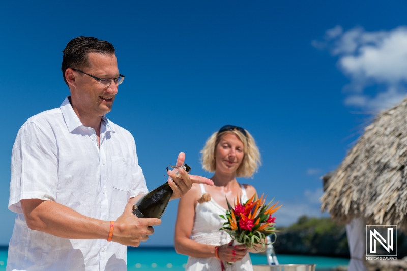 A Couple Celebrates a Special Occasion on the Beach With Champagne and Tropical Flowers While Enjoying a Sunny Day by the Ocean