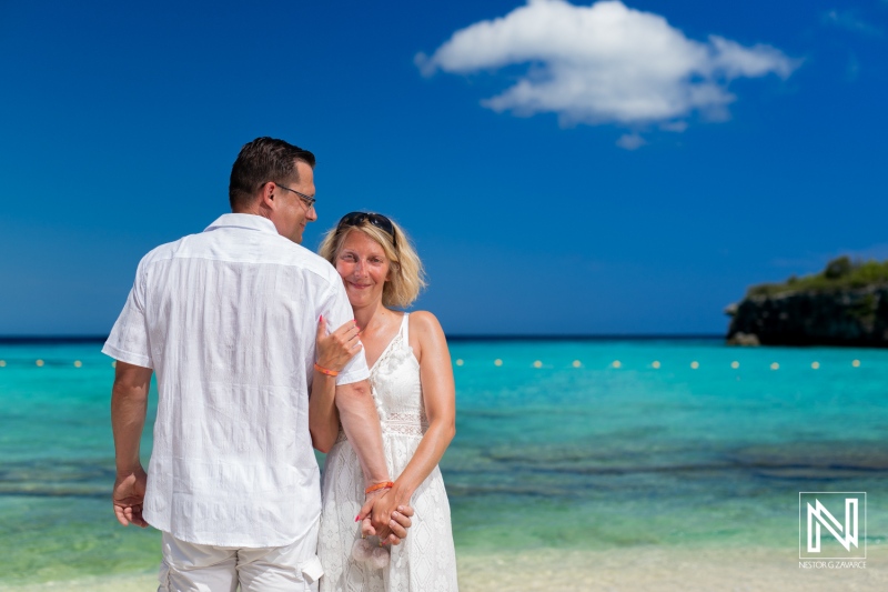 A Couple Joyfully Enjoying a Sunny Day on a Tropical Beach, Holding Hands and Smiling Against a Backdrop of Clear Blue Waters and a Bright Sky