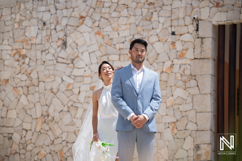 Couple prepares for wedding ceremony in Playa Hunku, Curacao on sunny day