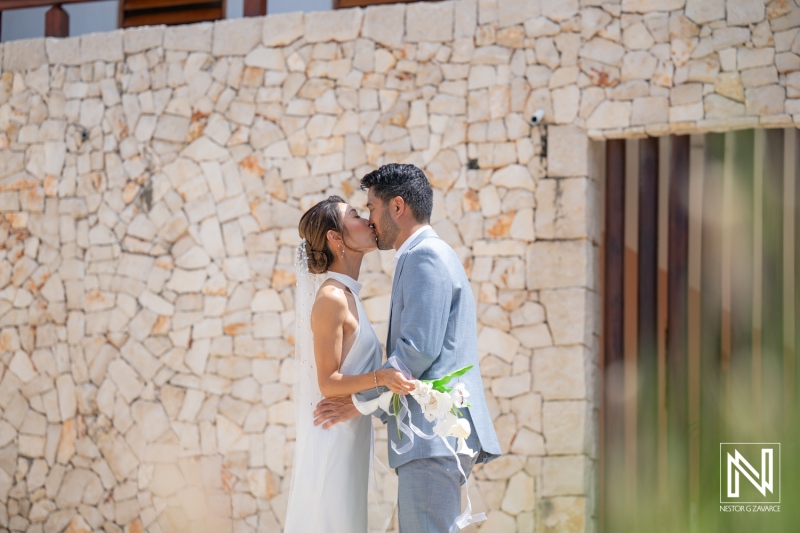 Wedding ceremony at Playa Hunku in Curacao features couple sharing a kiss