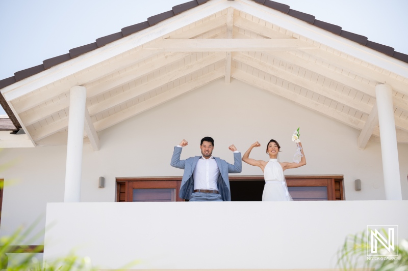 Wedding celebration at Playa Hunku in Curacao with couple posing on balcony