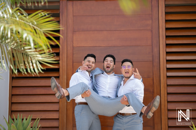 Groomsmen celebrate at a wedding in Playa Hunku, Curacao, capturing joyful moments with laughter and friendship