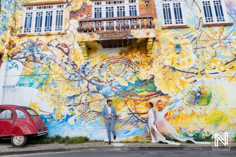 Couple shares vows during their wedding at Playa Hunku in Curacao near colorful mural