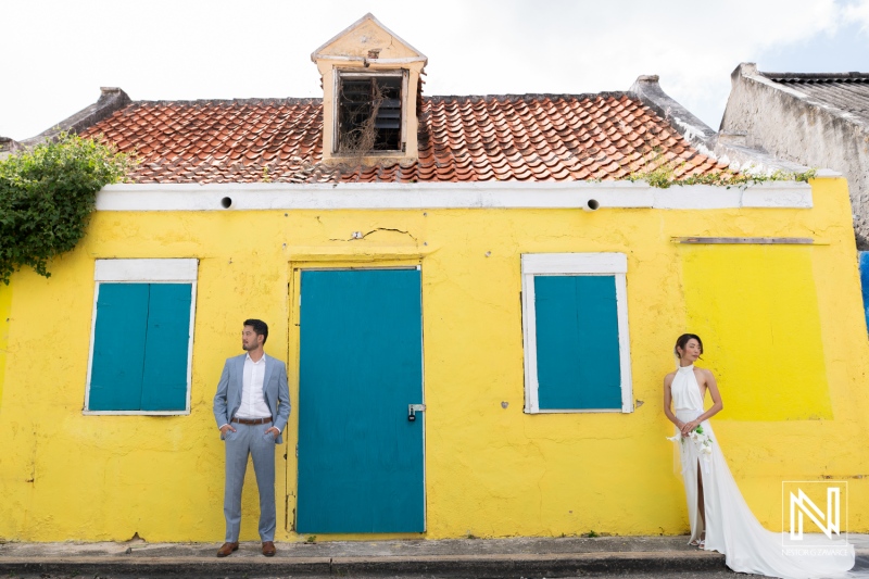 Wedding ceremony at Playa Hunku in Curacao with a couple near a bright yellow house