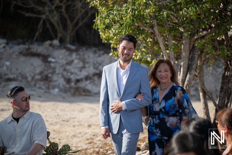 Couple walks down the aisle at a wedding ceremony in Playa Hunku, Curacao during a sunny day
