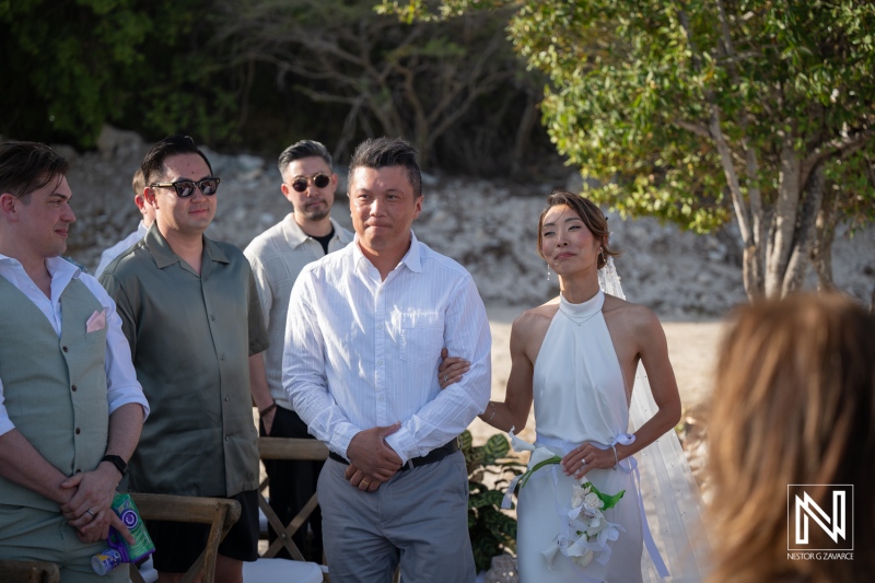 Wedding ceremony taking place at Playa Hunku in Curacao during a warm afternoon