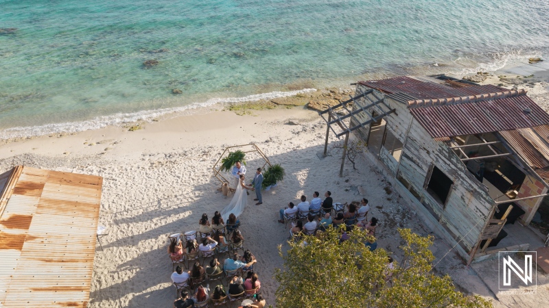 Wedding takes place at Playa Hunku in Curacao with guests gathered on the beach