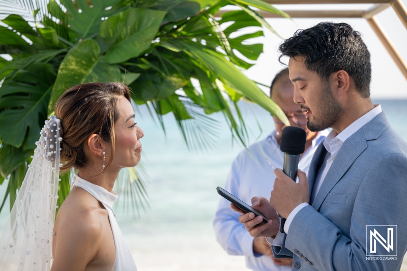 Wedding ceremony at Playa Hunku in Curacao with couple exchanging vows
