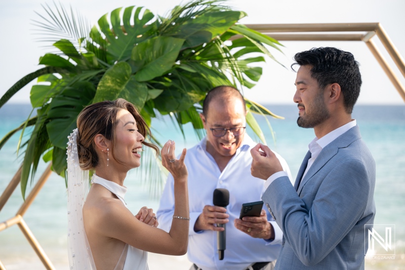 Couple exchanges vows at wedding ceremony by the water in Playa Hunku, Curacao