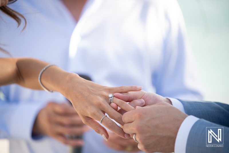 Couple exchange wedding rings at Playa Hunku during a ceremony in Curacao