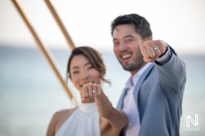 Couple shows wedding rings at Playa Hunku in Curacao during their wedding celebration