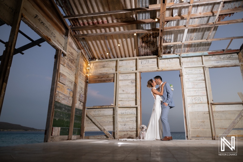Couple shares a moment during their wedding at Playa Hunku in Curacao as the sun sets by the ocean