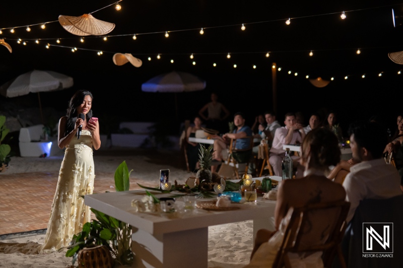 Ceremony at Playa Hunku with speeches and guests gathered on a warm night in Curacao