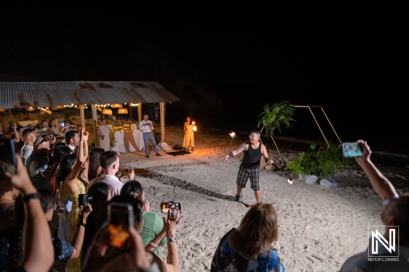 Celebration with fire dancing during a wedding at Playa Hunku in Curacao at night