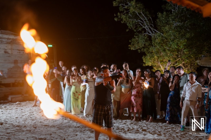 Wedding celebration with fire performance at Playa Hunku in Curacao during the evening