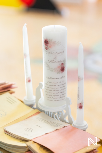 Wedding candles and decorative books at a beautiful wedding in Curacao on December 23, 2023, creating a serene atmosphere for the celebration