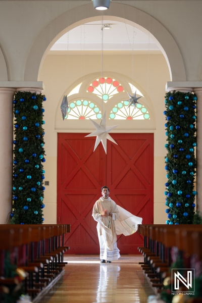 Wedding ceremony taking place in a beautifully decorated church in Curacao with vibrant colors and festive decor during the day