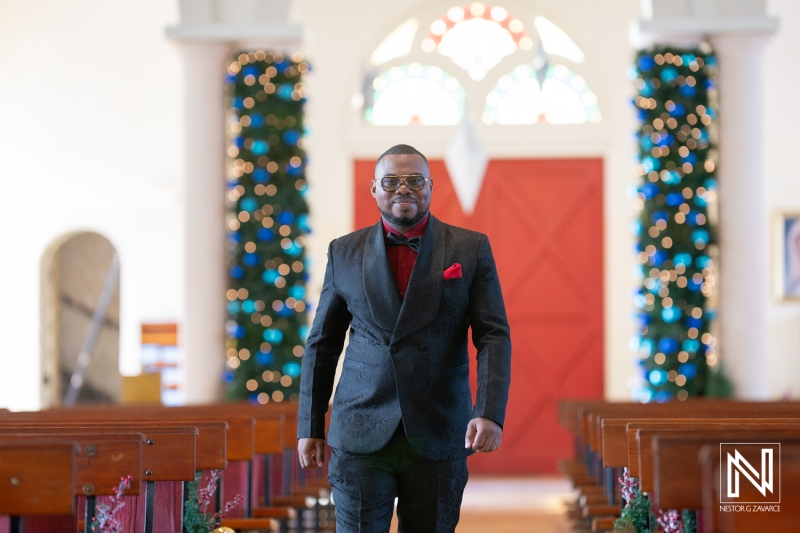 Elegant groom confidently walks down the aisle in a charming Curacao wedding venue during a festive celebration