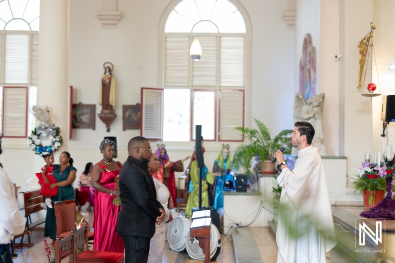 Wedding ceremony in Curacao featuring a couple and guests adorned in elegant attire celebrating love