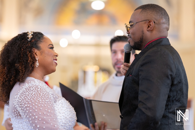 Couple exchanges vows during a romantic wedding ceremony in Curacao with captivating smiles and heartfelt moments