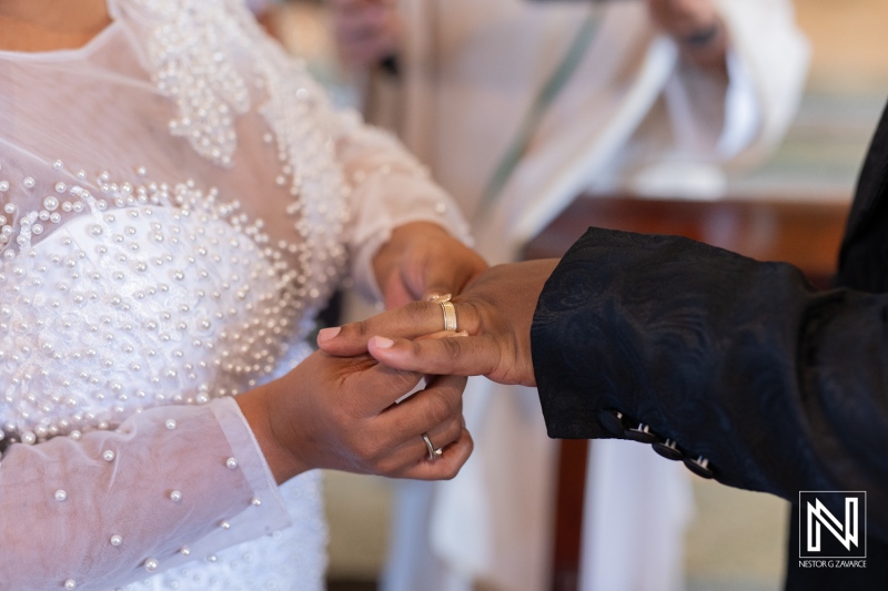 Couple exchanging wedding rings during a beautiful ceremony in Curacao with an elegant backdrop