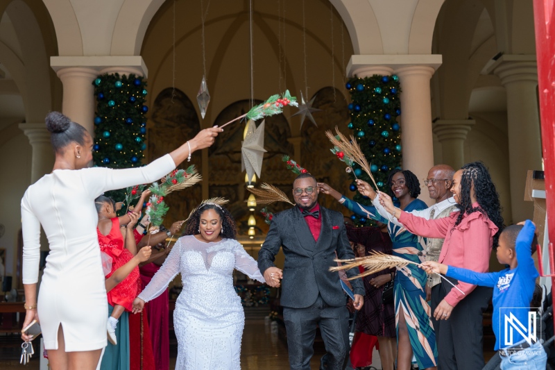 Wedding celebration in Curacao with joyful couple receiving blessings from family and friends inside a festive venue