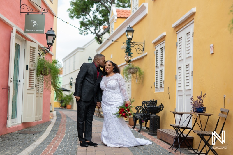 Couple shares a romantic moment in colorful Curacao streets during their wedding celebration