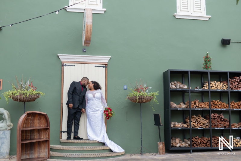 Wedding celebration in Curacao with a couple sharing a romantic moment at a charming venue adorned with fresh flowers and rustic decor