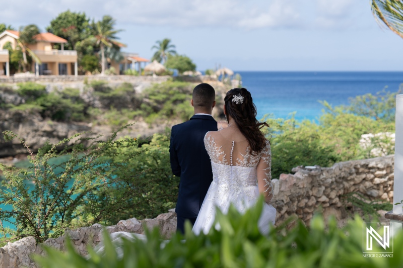 A Bride and Groom Admire the Stunning Coastal View During Their Wedding Ceremony at a Picturesque Seaside Location on a Sunny Day