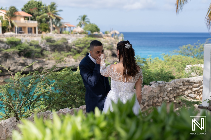 A Couple Exchanges Vows on a Scenic Cliffside Overlooking the Ocean During an Intimate Beach Wedding Ceremony at a Tropical Destination