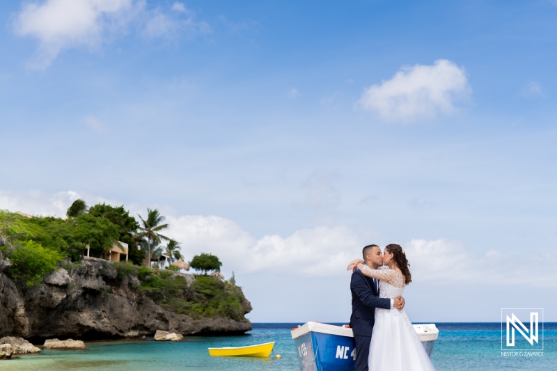 Couple Embraces on a Beautiful Beach in a Tropical Setting, Enjoying a Romantic Moment During Their Wedding Photoshoot at the Shore With Clear Blue Skies