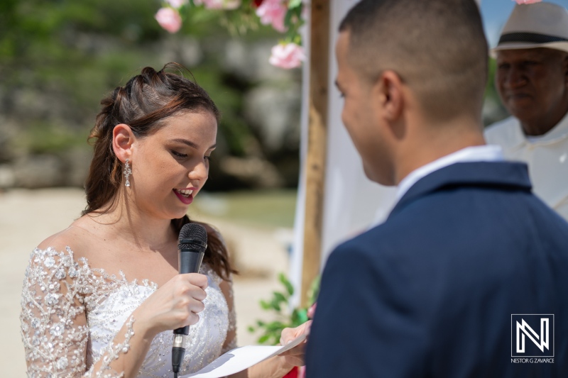 A Couple Exchanging Vows at a Beautiful Outdoor Wedding Ceremony Against a Picturesque Backdrop of Nature, Showcasing a Heartfelt Moment of Love and Commitment