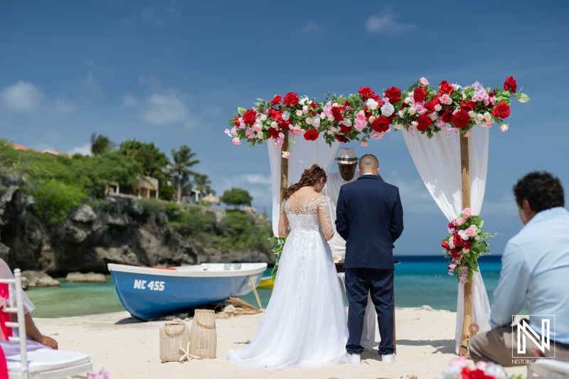 Beach Wedding Ceremony With Floral Decorations and a Scenic Backdrop of the Ocean on a Sunny Day