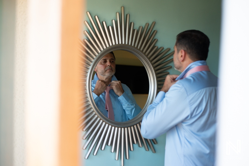 Groom getting into attire