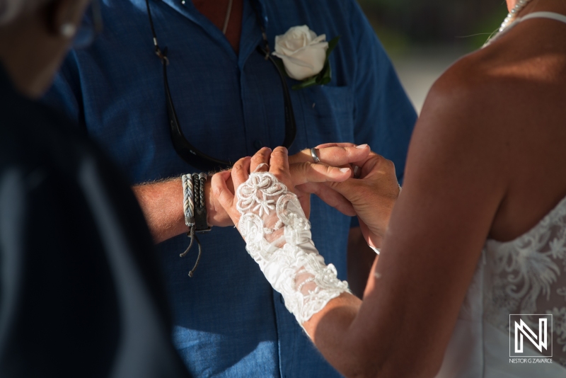 Bride putting the ring on the groom