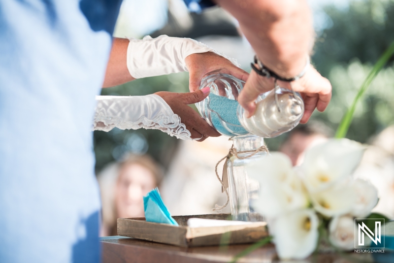 Bride and groom pouring sand into vase