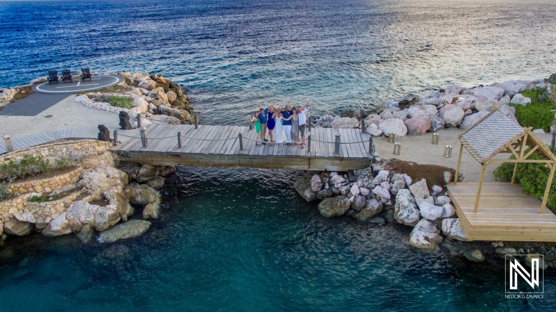 family of the bride and groom aerial shot on the pier