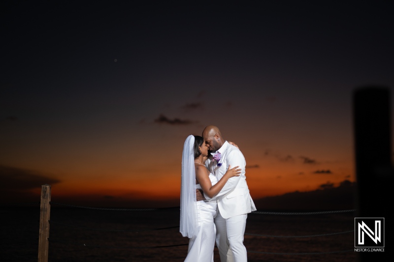 A romantic sunset wedding embrace on a beach, capturing love and joy as the couple shares a tender moment together at dusk