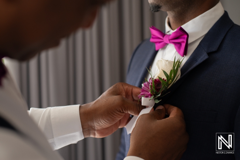 Groom getting into attire