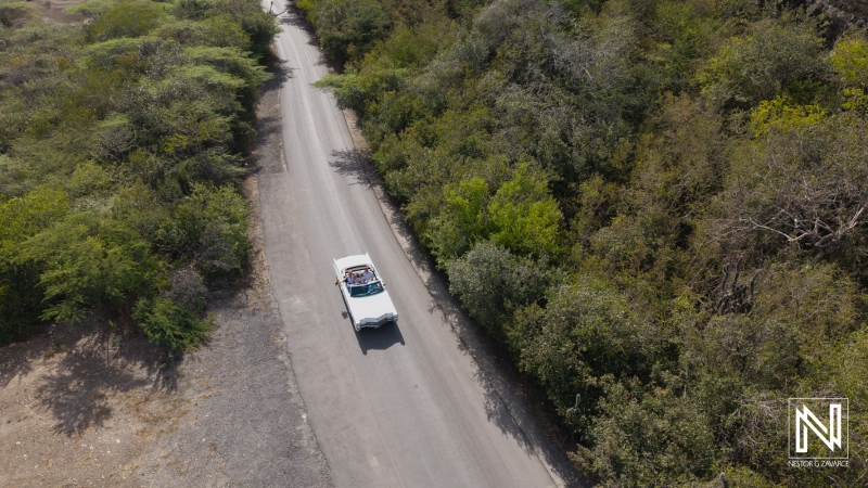 Couple drives to wedding at Daaibooi Beach in Curacao near The Kontiki Curacao Beach Resort