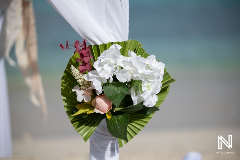 Wedding decoration at Daaibooi Beach in Curacao with floral arrangement and seaside background