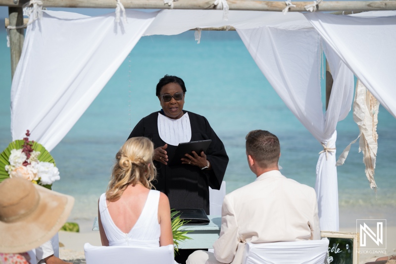 Wedding ceremony at Daaibooi Beach in Curacao near The Kontiki Curacao Beach Resort with guests and officiant present