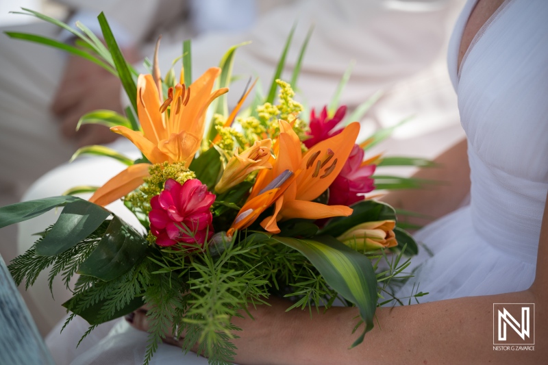 Wedding ceremony at Daaibooi Beach in Curacao with floral bouquet captured during the event