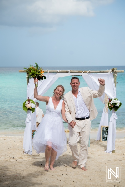 Couple celebrates wedding ceremony at Daaibooi Beach Curacao with joy and happiness