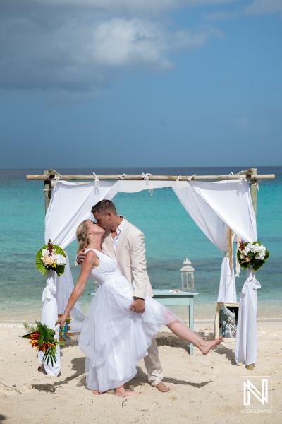 Wedding ceremony at Daaibooi Beach with couple celebrating love near the ocean in Curacao